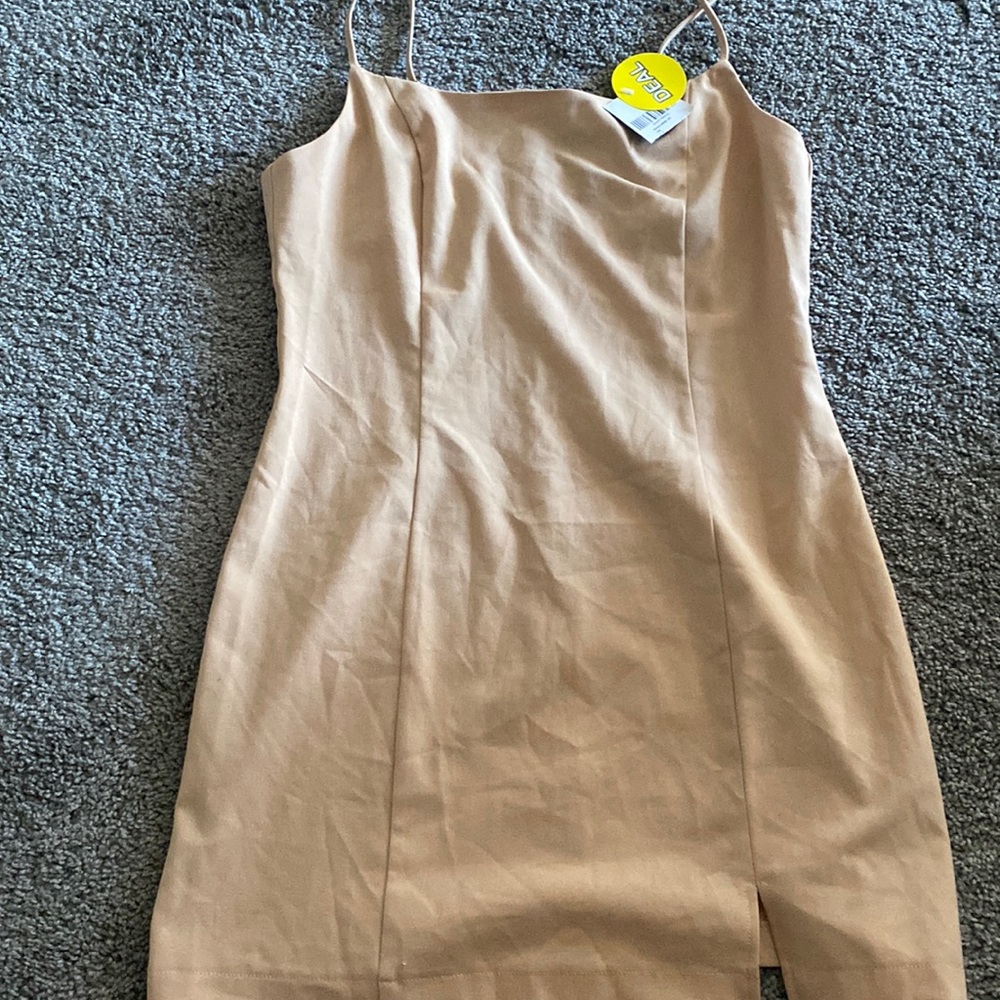 Tan mini dress with a cute little split. Would be cute with a white shirt😌